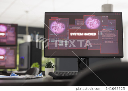 Vacant startup office displays computer screen with hacked system alert and error code. Digital security concept highlights cyber attacks, compromised servers and modern business vulnerability. Vacant startup office displays computer screen with hacked system alert and error code. Digital security concept highlights cyber attacks, compromised servers and modern business vulnerability. 141062325