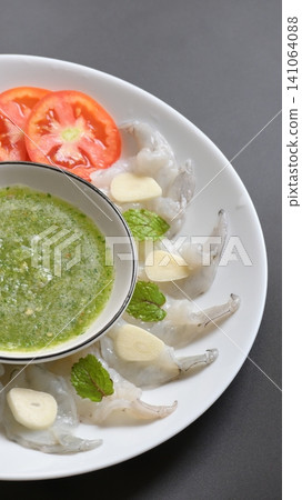 shrimp in fish sauce with Thai spicy seafood dipping sauce on white plate shrimp in fish sauce with Thai spicy seafood dipping sauce on white plate 141064088