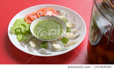 shrimp in fish sauce with Thai spicy seafood dipping sauce on white plate and umeshu shrimp in fish sauce with Thai spicy seafood dipping sauce on white plate and umeshu 141064089