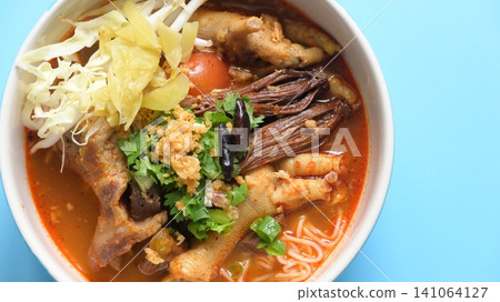 rice vermicelli with northern thai curry sauce on blue background rice vermicelli with northern thai curry sauce on blue background 141064127