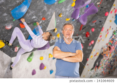 Adult man posing on climbing wall 141064609