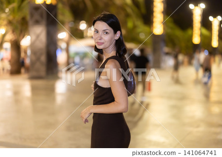 At night, smiling girl walks around old city district Barceloneta, in vicinage of Citadel Park At night, smiling girl walks around old city district Barceloneta, in vicinage of Citadel Park 141064741