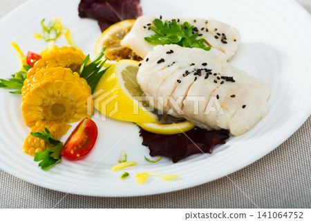 Hake steamed with corn, greens and lemon. Recipe Hake steamed with corn, greens and lemon. Recipe 141064752
