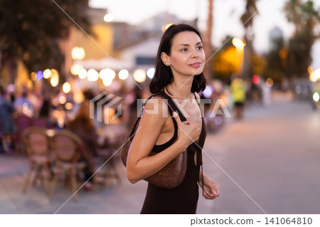 Young woman walking on a lively promenade of Barceloneta Young woman walking on a lively promenade of Barceloneta 141064810