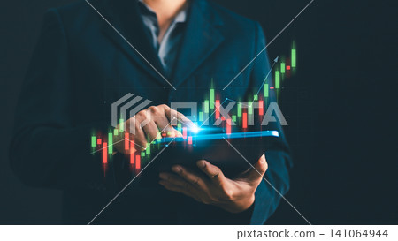 Businessman using digital tablet analyzing financial stock market trading graph. Concept of investment, cryptocurrency exchange, economic growth, funds management and forex data analysis Businessman using digital tablet analyzing financial stock market trading graph. Concept of investment, cryptocurrency exchange, economic growth, funds management and forex data analysis 141064944