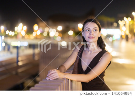 At night, smiling girl walks around old city district Barceloneta, in vicinage of Citadel Park At night, smiling girl walks around old city district Barceloneta, in vicinage of Citadel Park 141064994