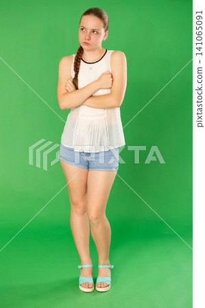 Upset teenage girl in white blouse is upset about the problems that have arisen. Chroma key compositing Upset teenage girl in white blouse is upset about the problems that have arisen. Chroma key compositing 141065091