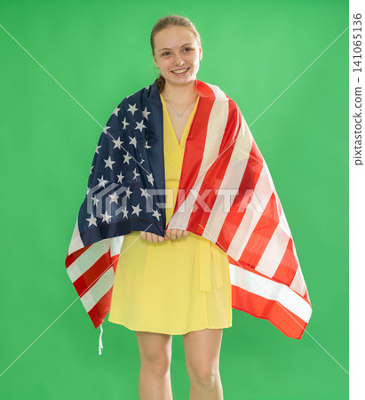 teen girl standing in dress with USA flag on chroma key background teen girl standing in dress with USA flag on chroma key background 141065136