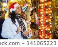 Portrait of a positive Latin American woman who came to a Christmas fair 141065223