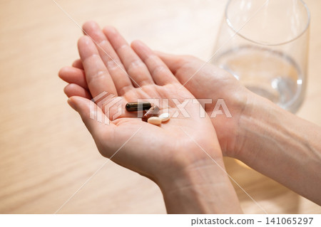 Woman taking medicine Woman taking medicine 141065297