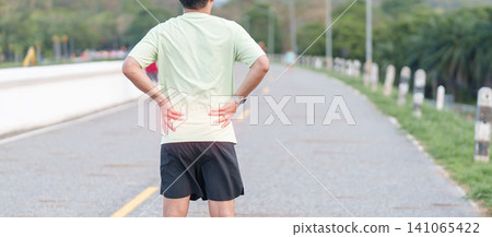 Adult male runner with back and waist ache due to piriformis syndrome and low back pain. man having muscle injury or spinal compression during running. Sports medicine and healthcare concept 141065422