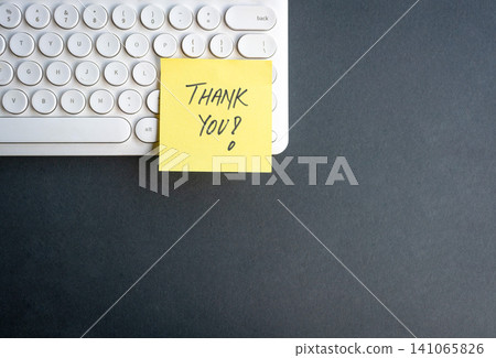 Thank you on yellow post it note on top of keyboard Thank you on yellow post it note on top of keyboard 141065826