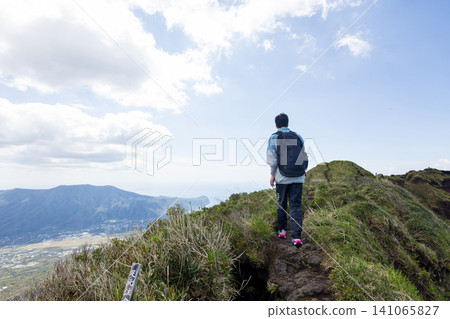 The back view of a student climbing Mount Hachijo-Fuji The back view of a student climbing Mount Hachijo-Fuji 141065827