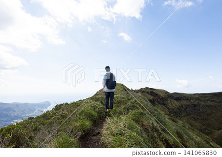 The back view of a student climbing Mount Hachijo-Fuji 141065830