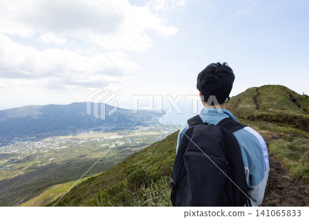 The back view of a student climbing Mount Hachijo-Fuji The back view of a student climbing Mount Hachijo-Fuji 141065833