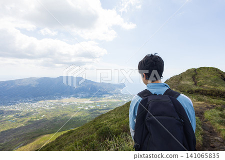 The back view of a student climbing Mount Hachijo-Fuji The back view of a student climbing Mount Hachijo-Fuji 141065835