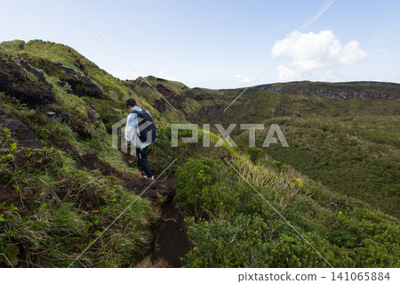 The back view of a student climbing Mount Hachijo-Fuji 141065884