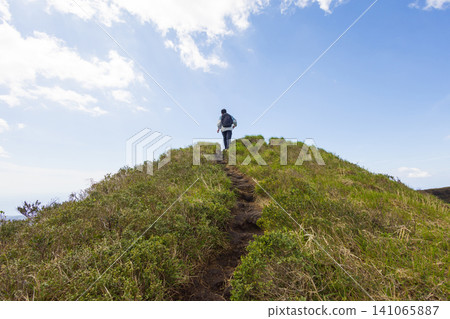 The back view of a student climbing Mount Hachijo-Fuji The back view of a student climbing Mount Hachijo-Fuji 141065887