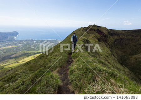 The back view of a student climbing Mount Hachijo-Fuji 141065888