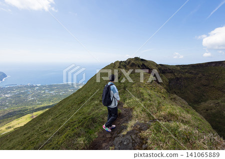 The back view of a student climbing Mount Hachijo-Fuji 141065889