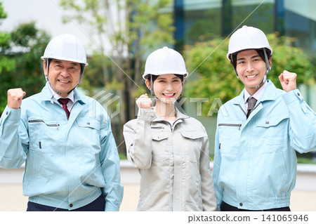Asian construction workers standing with smiles on their faces Asian construction workers standing with smiles on their faces 141065946