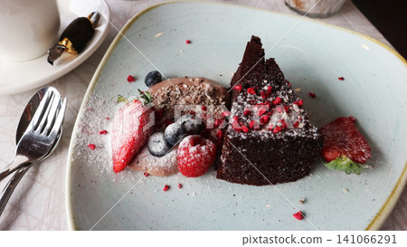 Gourmet Chocolate Cake Dessert with Berries and Ice Cream Gourmet Chocolate Cake Dessert with Berries and Ice Cream 141066291