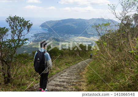 The back view of a student climbing Mount Hachijo-Fuji The back view of a student climbing Mount Hachijo-Fuji 141066548
