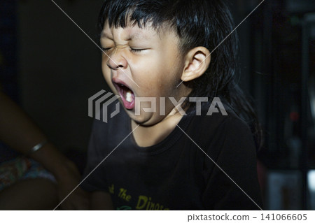 Toddler Sitting And Yawning Sleepily Toddler Sitting And Yawning Sleepily 141066605