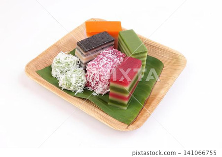 Assorted colorful layered soap bars on green leaf background Assorted colorful layered soap bars on green leaf background 141066755