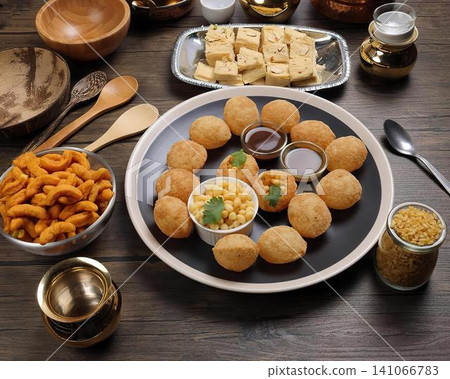 Plate of fried snacks with dips and drinks on dark table Plate of fried snacks with dips and drinks on dark table 141066783
