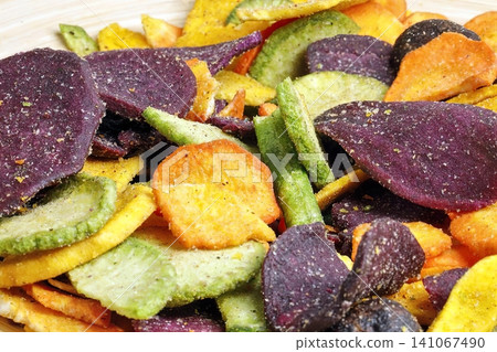 Close-up of colorful vegetable chips on a plate Close-up of colorful vegetable chips on a plate 141067490