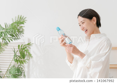 A woman drinking cold lemonade. A woman drinking cold lemonade. 141067992