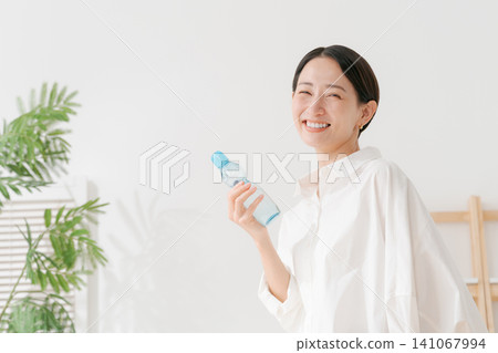 A woman drinking cold lemonade. A woman drinking cold lemonade. 141067994