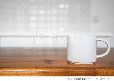 Close up of white coffee mug on wooden table right side Close up of white coffee mug on wooden table right side 141068050