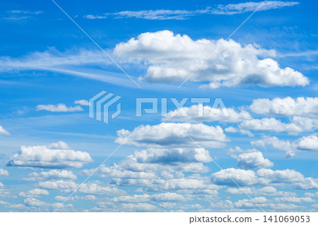 Dramatic white cumulus clouds floating across deep blue summer sky natural weather background scenic view Dramatic white cumulus clouds floating across deep blue summer sky natural weather background scenic view 141069053