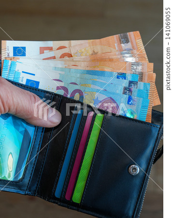 Open Black Leather Wallet with Euro Banknotes and Payment Cards Close Up Personal Finance Concept Open Black Leather Wallet with Euro Banknotes and Payment Cards Close Up Personal Finance Concept 141069055