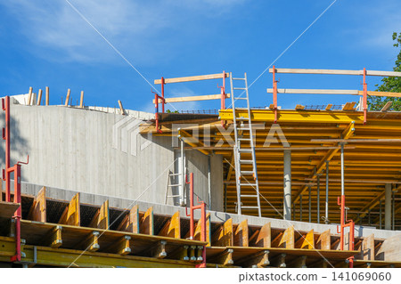 Concrete Building Construction with Formwork, Scaffolding and Ladders at Active Building Site Project 141069060