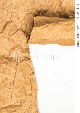 Vertical torn crumpled brown kraft paper background with white copy space. Ripped edge of recycled cardboard sheet for mobile story banner texture and eco friendly design element Vertical torn crumpled brown kraft paper background with white copy space. Ripped edge of recycled cardboard sheet for mobile story banner texture and eco friendly design element 141069195