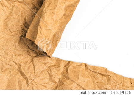 Torn crumpled brown kraft paper border with copy space on white background. Ripped edge of recycled cardboard sheet for abstract banner texture and eco friendly design element Torn crumpled brown kraft paper border with copy space on white background. Ripped edge of recycled cardboard sheet for abstract banner texture and eco friendly design element 141069196