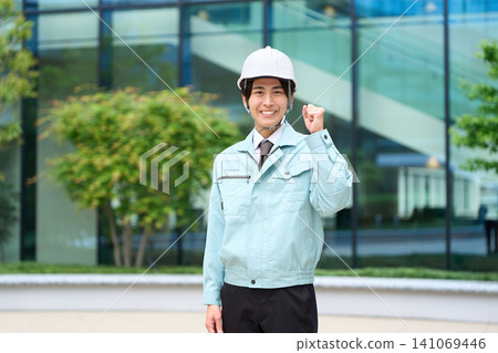 Asian man standing in work clothes 141069446