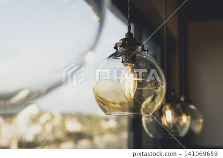 A terrace illuminated by round glass pendant lights. 141069659