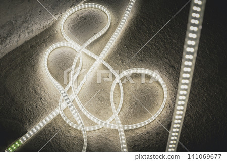 Close-up of an LED rope light with a green connector. Close-up of an LED rope light with a green connector. 141069677