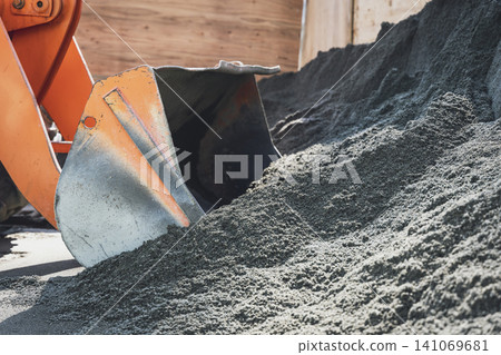 Close-up of the bucket of an excavator scooping up gravel. Close-up of the bucket of an excavator scooping up gravel. 141069681
