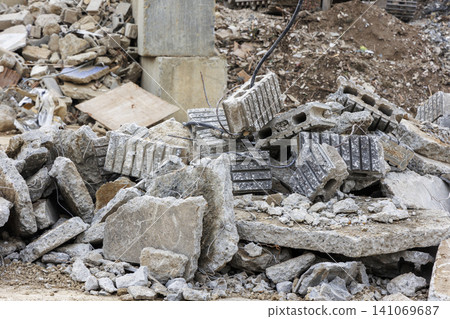 Demolition site rubble with concrete blocks and rebar scattered around. Demolition site rubble with concrete blocks and rebar scattered around. 141069687