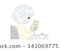 A senior woman sits in a chair, drinking coffee and using her smartphone. 141069775