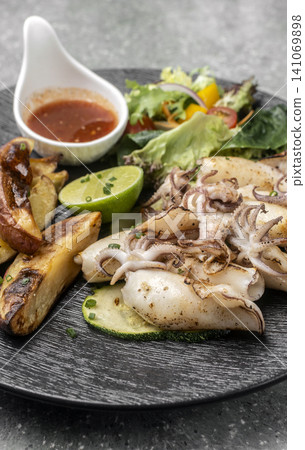 mediterranean grilled fresh squid meal on restaurant table mediterranean grilled fresh squid meal on restaurant table 141069898