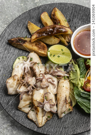 mediterranean grilled fresh squid meal on restaurant table mediterranean grilled fresh squid meal on restaurant table 141069904