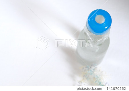 An overhead view of a ramune bottle and baby's breath flowers. An overhead view of a ramune bottle and baby's breath flowers. 141070262