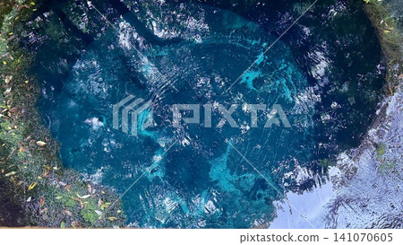 A drop of water falls into the beautiful blue spring-fed pond, creating lovely ripples. A drop of water falls into the beautiful blue spring-fed pond, creating lovely ripples. 141070605