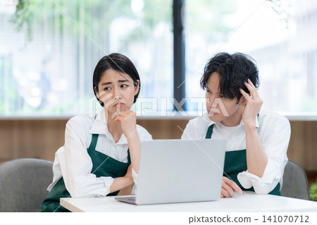 young male and female cafe staff young male and female cafe staff 141070712